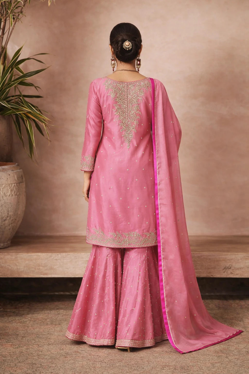 Pink designer Ruhika Kurta Set with matching dupatta, shown from the back, featuring traditional festive embroidery and detailing.