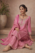 Kathaa Ruhika pink designer kurta set with matching dupatta, featuring intricate embroidery, worn by a woman sitting.